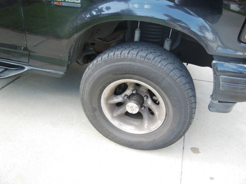Side view of a black Ford Bronco XLT showing the front wheel and fender area