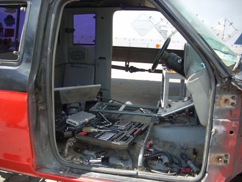 1992 Ford Ranger - Tools and parts are laid out inside a truck cab that appears to be undergoing repairs or disassembly.