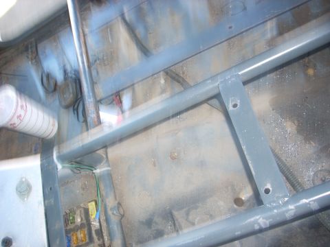 1992 Ford Ranger - The interior of a vehicle shows a roll cage structure and a visible fuse box.