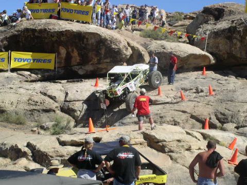 1979 Ford Bronco - A custom-built off-road buggy navigates a challenging rocky terrain during a competition.