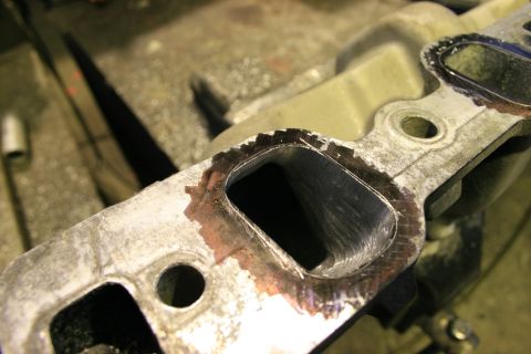1973 Ford Ranchero - Close-up of an engine intake manifold, showing machined surfaces and gasket mating areas.