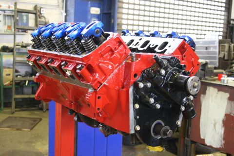 1973 Ford Ranchero - A rebuilt V8 engine sits on a stand, ready for installation.