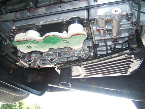 1988 Ford Bronco - Underside view of a vehicle's transmission components, showing the valve body and pan.