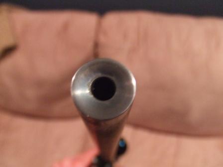 1996 Ford Bronco - The image shows the muzzle of a firearm, with a couch visible in the blurred background.
