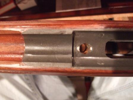 1996 Ford Bronco - Close-up view of a gun receiver, showing internal metal components and wooden stock.