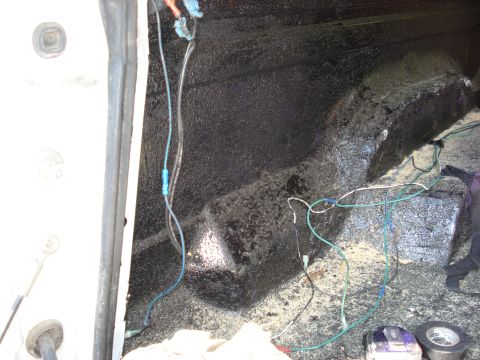 1992 Ford C-350 (Centurion Conversions) - Wiring is visible in the interior of a vehicle, with sound deadening material applied to the surfaces.