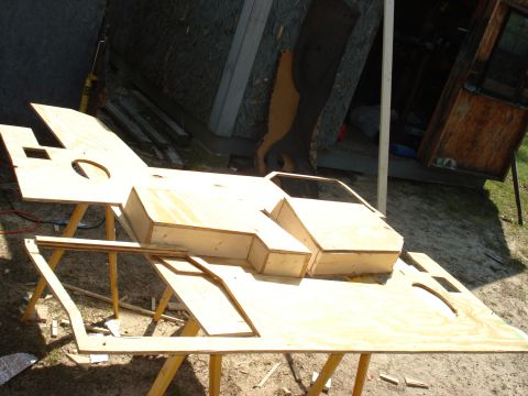 1992 Ford C-350 (Centurion Conversions) - A wooden mock-up of a vehicle body is being constructed on sawhorses in an outdoor setting.