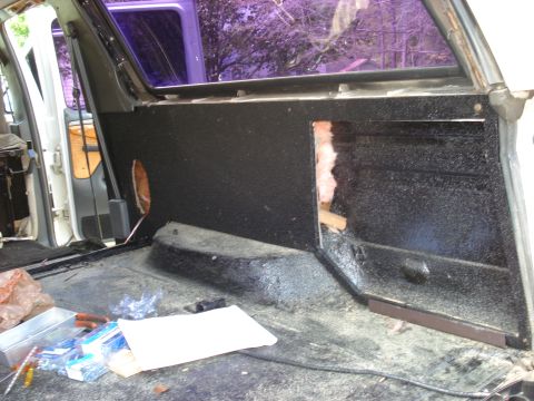 1992 Ford C-350 (Centurion Conversions) - The interior of a vehicle is shown with exposed insulation and tools, indicating ongoing work.