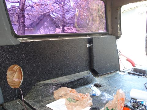 1992 Ford C-350 (Centurion Conversions) - Interior view of a vehicle, focusing on the rear wall panel and window.