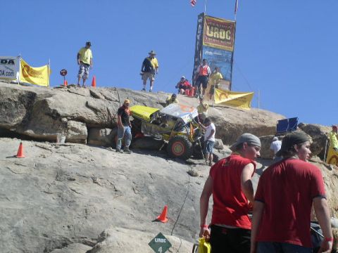 1979 Ford Bronco - Spectators watch an off-road buggy navigate a steep, rocky incline during an event.