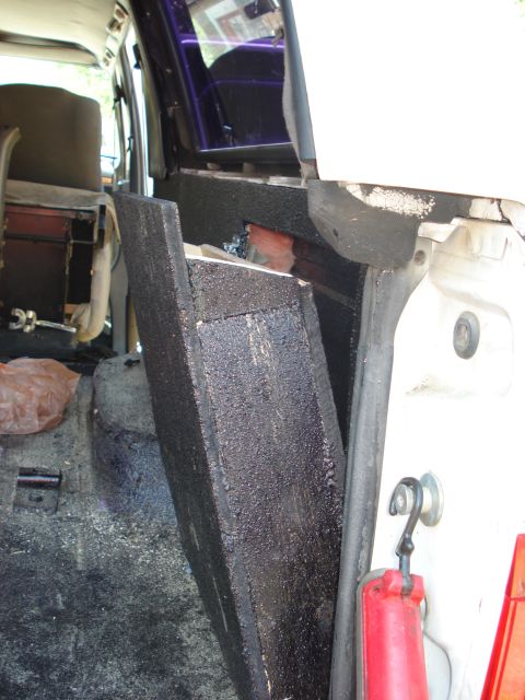 1992 Ford C-350 (Centurion Conversions) - Close-up view of custom interior paneling and insulation, likely for sound dampening or modification.