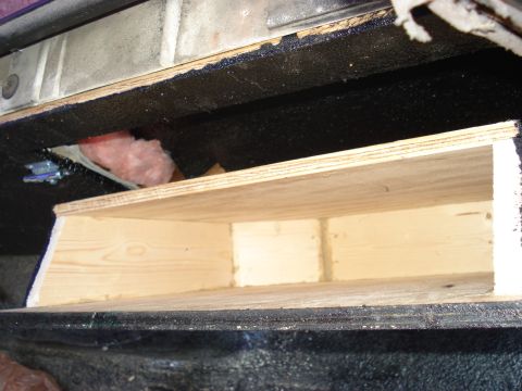 1992 Ford C-350 (Centurion Conversions) - A close-up view of a custom-built wooden storage compartment, likely installed in a vehicle's interior.