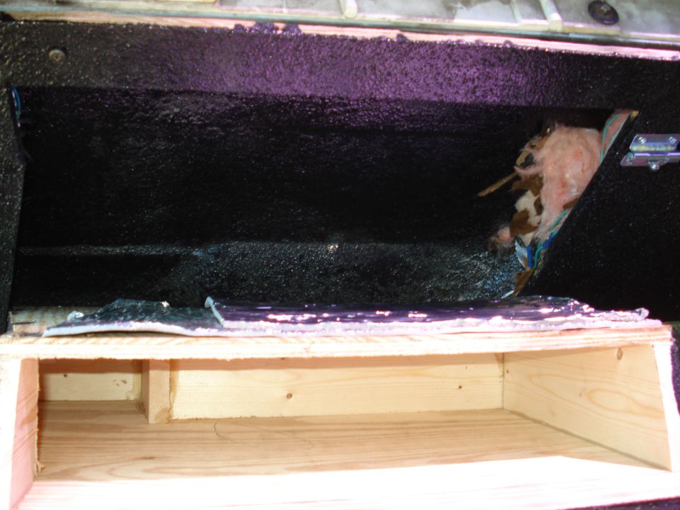 Plywood storage box with black bedliner-coated cavity, purple masking tape and pink insulation