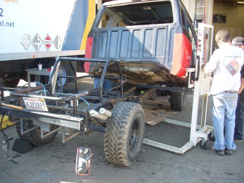 1992 Ford Ranger - A custom off-road vehicle is being worked on, with a truck cab visible in the background.