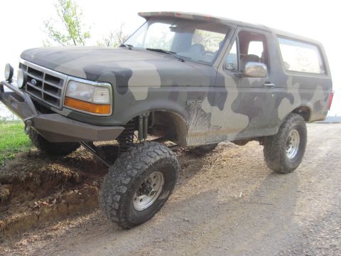 1995 Ford Bronco - This 1995 Ford Bronco features a camouflage paint job and a lifted suspension, giving it an off-road appearance.