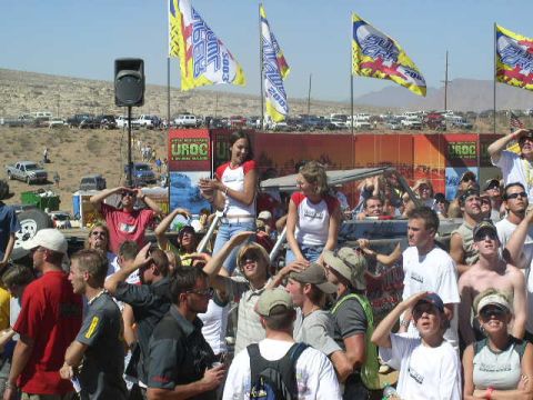 1979 Ford Bronco - Spectators gather at an event with flags and vehicles visible in the background.