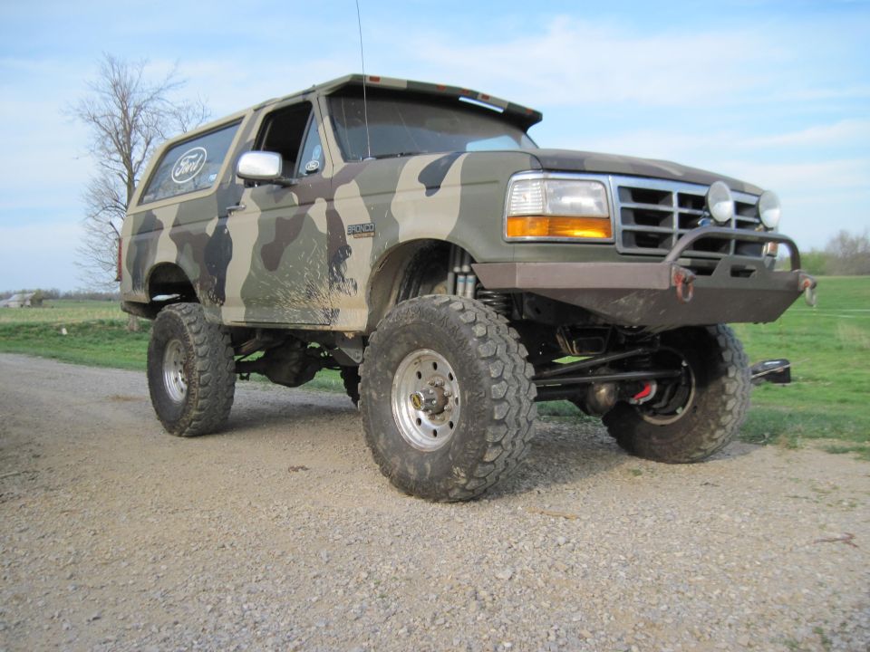 Camouflaged 1995 Ford Bronco with lifted suspension and aftermarket bumper