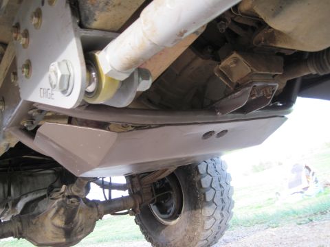 1995 Ford Bronco - Close-up view of a vehicle's undercarriage, focusing on suspension and drivetrain components.