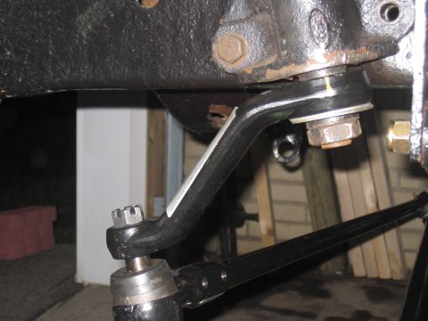 1979 Ford Bronco - Close-up view of a vehicle's steering linkage system, showing various mechanical components.