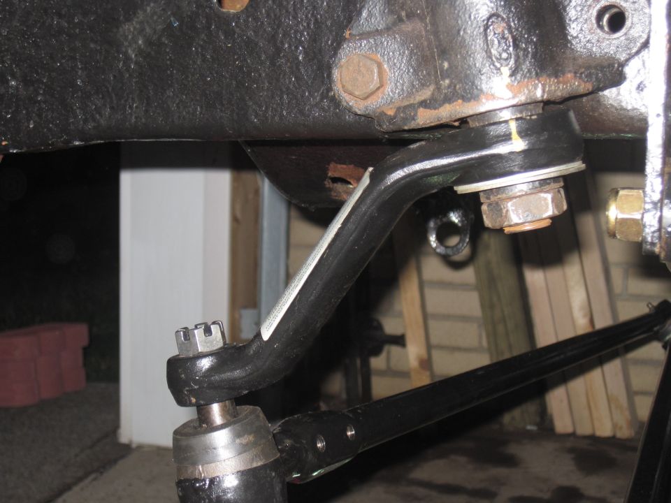 Black steering linkage part with nuts and bolts
