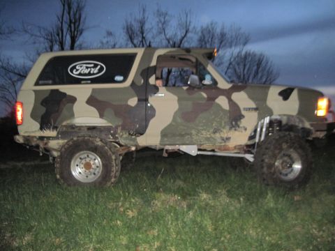 1995 Ford Bronco - This Ford Bronco has a custom camouflage paint job and appears to be modified for off-road use.