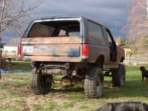 1988 Ford Bronco - This heavily modified Ford Bronco shows significant rust and a lifted suspension.