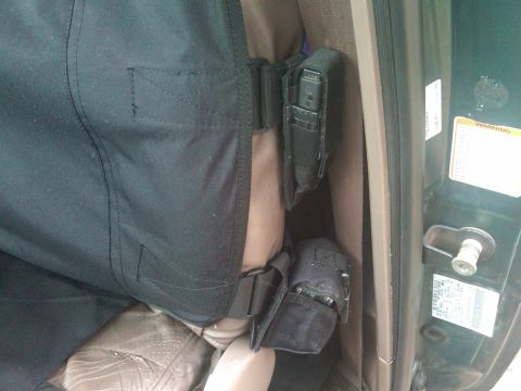 1993 Ford Bronco - Interior view of a vehicle's seat with attached storage pouches and a door jamb sticker.