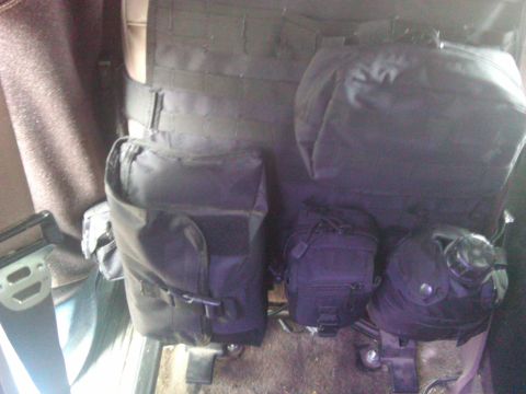 1993 Ford Bronco - A tactical seat organizer with pouches is attached to the interior of a vehicle.