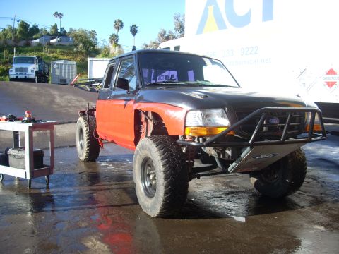 1992 Ford Ranger - Modified 1992 Ford Ranger pickup truck with custom off-road bumper and orange fenders.