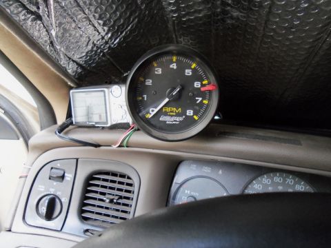 2000 Mercury Grand Marquis - Aftermarket tachometer and GPS unit installed on the dashboard.
