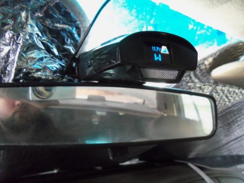 2000 Mercury Grand Marquis - Interior view of a vehicle's rearview mirror and a radar detector displaying voltage.