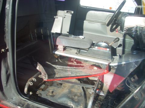1992 Ford Ranger - The interior of a truck shows exposed metal flooring and a torn driver's seat.