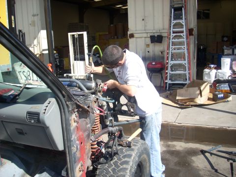 1992 Ford Ranger - A person is working on the engine of a vehicle that appears to be undergoing modifications or repairs.
