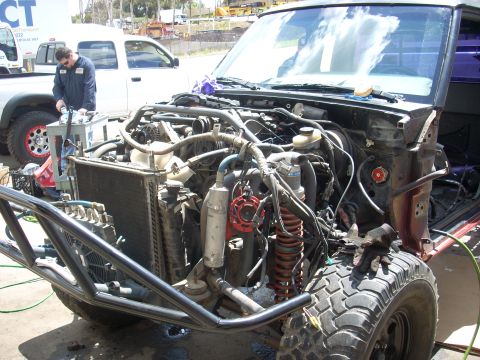 1992 Ford Ranger - A 1992 Ford Ranger truck is shown with its engine compartment open and front end modified for off-road use.
