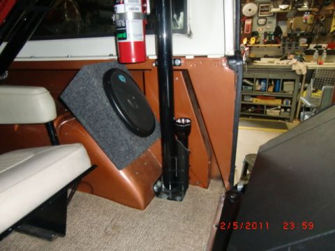 1973 Ford Bronco - The interior of a 1973 Ford Bronco shows a custom speaker box and a fire extinguisher mounted on the interior panel.