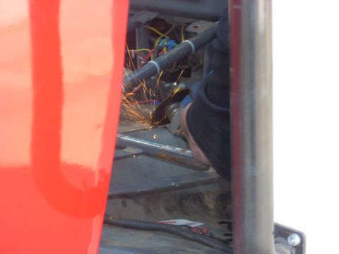 1992 Ford Ranger - Sparks fly as metal is ground inside a vehicle's interior, possibly during modification.