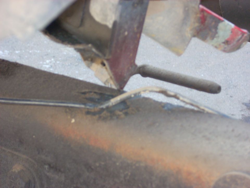 close-up of rusty vehicle frame with some linkage components
