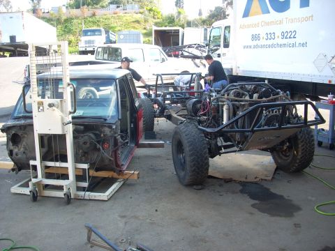 1992 Ford Ranger - Two vehicles are being worked on, one is a truck cab and the other is a custom off-road buggy chassis.