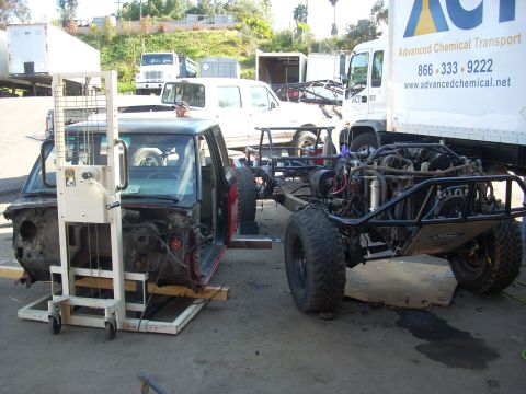 1992 Ford Ranger - A truck cab is being lifted while a custom chassis with its engine is parked nearby.
