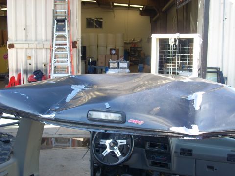 1992 Ford Ranger - The vehicle's hood is severely damaged, with visible dents and peeling paint, obscuring any year identification.