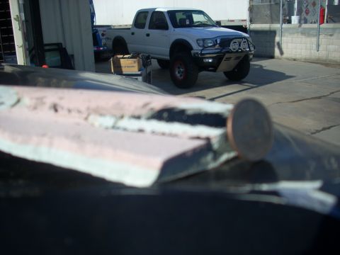 1992 Ford Ranger - This white Toyota Tacoma pickup truck has been modified with an aftermarket bumper and off-road tires.