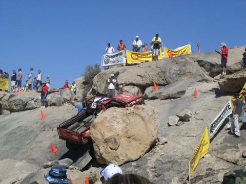 1979 Ford Bronco - Competitors navigate a challenging rocky terrain during an off-road race event.