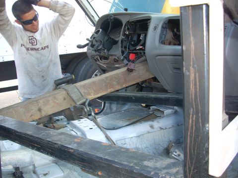 1992 Ford Ranger - A man works on the interior of a truck, which appears to be undergoing some form of modification or repair.