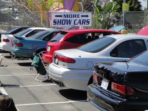 1993 Ford Taurus - Several cars are parked in a lot, with a sign indicating 'More Show Cars'.