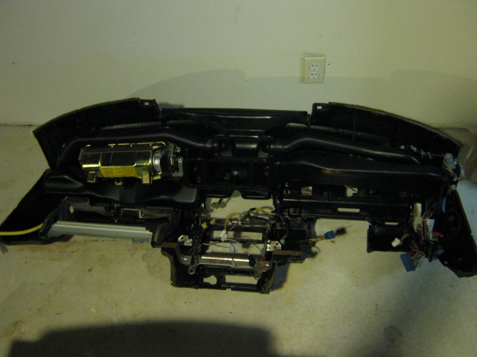 Front view of a removed dashboard showing HVAC and structure