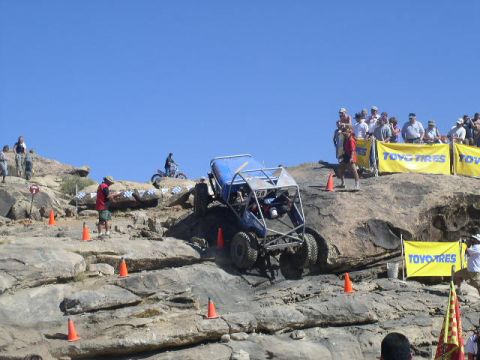 1979 Ford Bronco - A custom-built off-road vehicle navigates a challenging rock course with spectators observing the event.