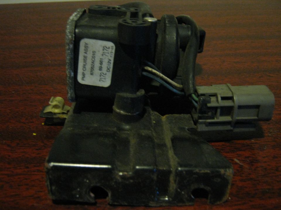 Cruise control vacuum pump and bracket assembly on a wood table