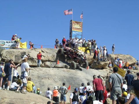 1979 Ford Bronco - Spectators watch an off-road buggy ascend a steep, rocky incline during an event.