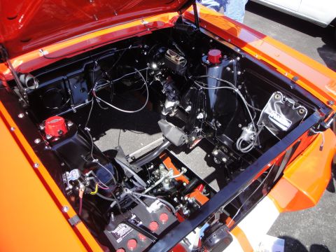 1993 Ford Taurus - The engine bay of an orange vehicle is shown, a clean and organized layout with black and red components.