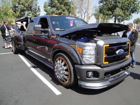 1993 Ford Taurus - A customized Ford Super Duty truck is displayed with its hood open, revealing the engine compartment.